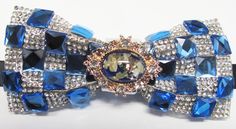 "Beautiful pre-tied and adjustable double tiered banded bow tie Crystal Beaded Will adjust from 13\" through 20\" neck. Bow dimensions 2.5\" x 4.5\". Bow tie Always made by hand and to your special order. Weddings and groups are welcome." Elegant Blue Ribbon Bow, Blue Bow With Butterfly Knot For Wedding, Blue Bow Tie With Ribbon As A Gift, Blue Ribbon Bow For Party, Blue Party Bow With Ribbon, Blue Wedding Bow With Butterfly Knot, Adjustable Blue Bow With Ribbon, Adjustable Blue Ribbon Bow, Adjustable Blue Bow With Bow Tie Back