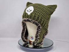 a knitted hat with a white skull on it's side and a fur lined brim