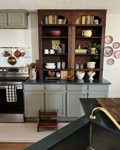 the kitchen is clean and ready to be used for cooking or baking, with dishes on shelves above the stove