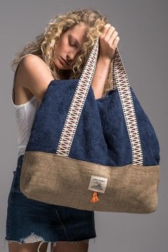 a woman holding a large black and tan bag