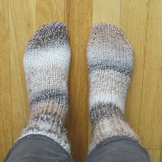 the feet of a person wearing gray and white socks