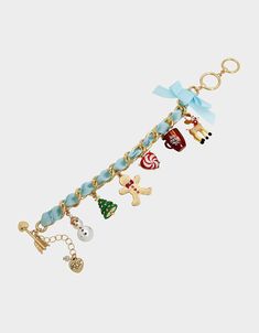 a gold bracelet with charms on it and an elephant, snowman, christmas tree