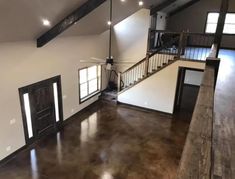 an empty living room with hard wood floors