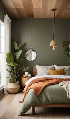 a bedroom with a bed, mirror and potted plants on the wall above it