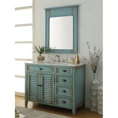 a bathroom vanity with a mirror above it and a rug on the floor next to it