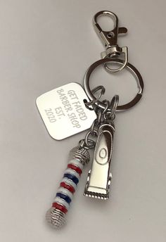 Barber shop pole key chain with Barber clipper charm. 3D pole thick metal. Perfect for barbers graduating or for that favorite barber. Key chain comes with barber pole, Barber 3d clipper charm, and personalized engraved stainless steel charm. Barber pole and clippers are metal alloy silver in color. Gifts For Barbers, Barber Gift Ideas, Barber Bus, Stalking Stuffers, Barber Shop Pole, Bridal Hair Tiara, Barber Shop Interior, Barber Gifts, Barber Equipment