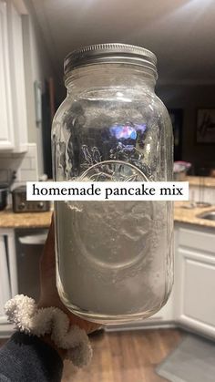 someone holding up a jar with homemade pancake mix in it's hand and the words homemade pancake mix written on it