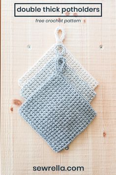 two crocheted potholders sitting next to each other on a wooden surface,