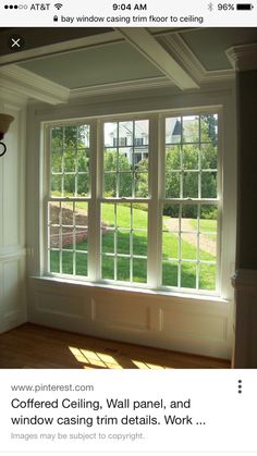 the sun shines through two windows in an empty room