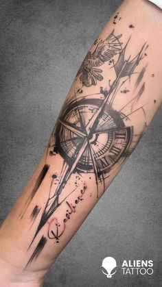 a black and white compass tattoo on the arm