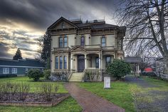 an old victorian style house on a cloudy day