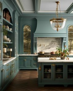 a large kitchen with blue cabinets and wood flooring, along with a chandelier hanging from the ceiling