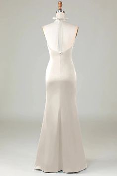 the back of a white wedding dress on a mannequin