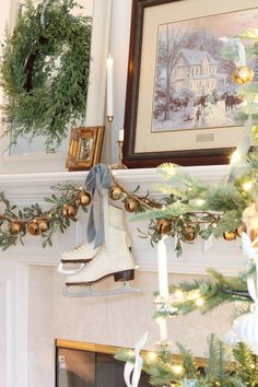 a christmas tree decorated with evergreen garland and ice skates hanging from the mantel