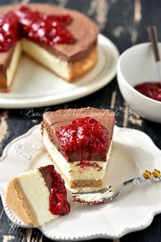 there is a piece of cheesecake on the plate with raspberry toppings