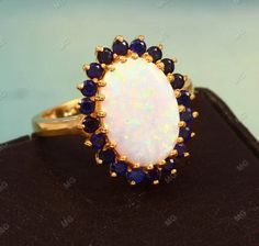 an opal and sapphire ring on display