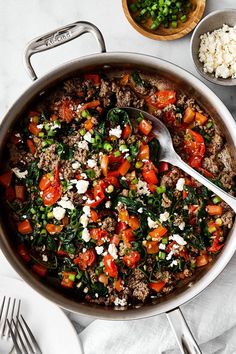 a pan filled with meat, vegetables and rice