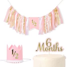 pink and gold first birthday decorations including a cake