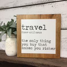 a wooden sign that says travel the only thing you buy that makes you richer