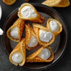 an overhead view of some food on a plate with sour cream in the middle and other foods around it