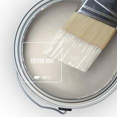 a paint can with a brush in it and the words cotton knit written on it