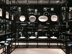 a room filled with lots of black and white plates