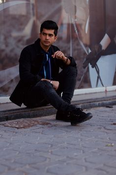 a man sitting on the ground with his legs crossed