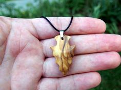 I hand-carved this one-of-a-kind arrowhead pendant from Spalted Exotic Olivewood with very unique spalting lines. It's fully carved in the round on both sides so you can hang either way. I like the look of primitive arrowheads so I emulate that style in my carvings.  A hand rub finish is applied and then the pendant is buffed to a buttery smooth final finish that feels amazing to the touch.  You can choose from a variety of necklace/cording options including: 18" or 22" stainless steel chain A v Artisan Arrowhead Necklace For Gift, Brown Arrowhead Necklace For Gift, Rustic Arrowhead Necklace For Gift, Arrowhead Pendant, Natural Necklace, Minimalist Pendant, Arrowhead Necklace, Hand Wipes, Modern Necklace