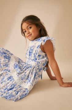 Summery sweetness pervades this floral-splashed dress fashioned from kid-friendly cotton with airy flutter sleeves and delicate lace trim. Back button closure; ties at back Lined 100% cotton Machine wash, tumble dry Imported Kids Outfits Daughters, Fashion Factory, Kids Summer Dresses, Wild Meadow, French Kids, Kids Fashion Dress, Dress 2024, Laura Ashley, Labour