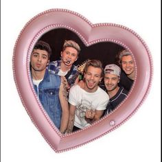 a heart - shaped photo frame with one direction band members in the middle, and an emo logo on the front