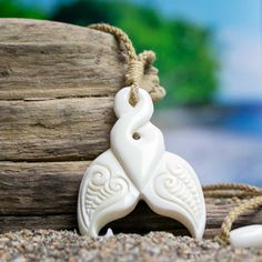 High-Quality Bone Art - Sold by Bali Necklaces. www.balinecklaces.com Hand carved on the Tropical Island of Bali. Each Bali Necklace helps to fund Coral Reef Conservation! Learn about our efforts! Just as human finger prints are unique to each person, each whale tale is unique to the individual whale. When excited, whales slap their flukes on the surface of the sea creating a powerful clap. They represent power that is only intensified by the strength of the sea. The Whale Tail represents power, individuality and grace. Pendant Materials: Repurposed, Water-Buffalo Bone Pendant size: Approximately 2 inches (5 cm). Cord: Hand-Braided, Bamboo Cotton. One size fits all. Adjustable from choker up to 26 inches. Unique Carved White Necklace, White Carved Pendant Necklaces, Unique White Carved Necklace, White Carved Pendant Necklace, Artisan Carved White Necklace, White Carved Amulet Necklace, Traditional White Carved Necklaces, Artisan White Engraved Necklace, Whale Tale