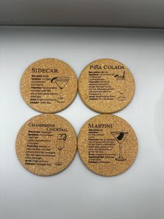 four cork coasters with different types of drinks and names on the back of them