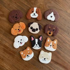 small dog magnets are arranged on a wooden surface