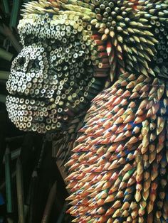 an animal made out of colored pencils