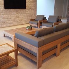 a living room filled with furniture and a flat screen tv mounted to the side of a wall