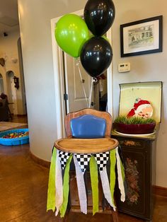 a chair with some black and green balloons on it