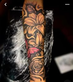 a woman's arm with flowers and butterflies on it