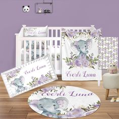 a baby crib bedding set with purple flowers and an elephant