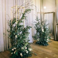 there are flowers and greenery on the floor next to each other in front of a mirror