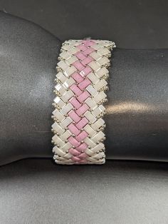 Pearlized White and Rose half Tila beads create delicate feminine beautifully with subtle coloring in this easy to wear bracelet. The herringbone weave in this supple bracelet creates a silky feel against your skin. The rectangular beads are glass, but the bracelet is light and very flexible. The longitudinal stripe pattern result in a woven or stitched look. The magnetic closure in complementary silver makes this bracelet easy to put on and take off. This bracelet is designed for everyday wear Herringbone Bracelet, Bracelet Easy, Tila Beads, Delicate Feminine, Business Wear, Formal Business, Casual Attire, Magnetic Closure, Stripes Pattern