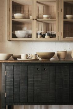 a cabinet with bowls and plates on it