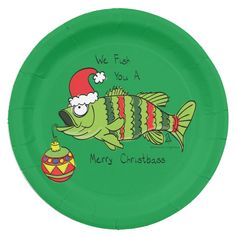 a green paper plate with a fish wearing a santa hat