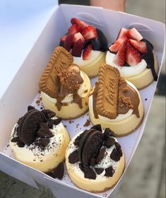 a box filled with assorted desserts sitting on top of a table