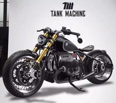 a black and gold motorcycle parked in front of a tank machine sign with the words tank machine on it