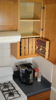 a small kitchen with an oven, stove and cupboards on the wall above it