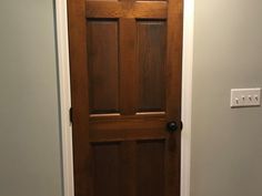 a wooden door in the corner of a room