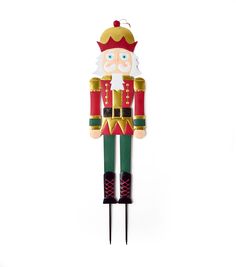 a nutcracker ornament on a white background