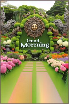 the sign for good morning is surrounded by colorful flowers and plants in front of it