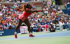 a female tennis player is in mid air after hitting the ball with her racket