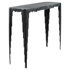 a black table with spikes on the legs